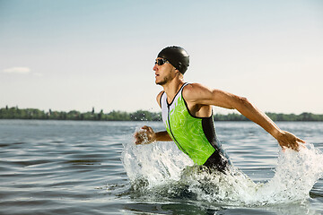 Image showing Professional triathlete swimming in river\'s open water