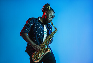 Image showing Young african-american jazz musician playing the saxophone