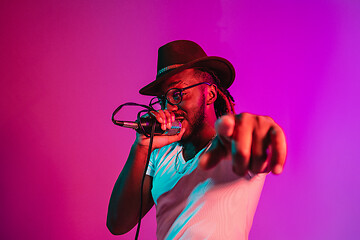 Image showing Young african-american jazz musician singing a song