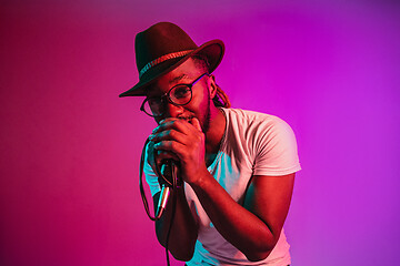 Image showing Young african-american jazz musician singing a song