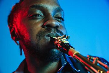 Image showing Young african-american jazz musician playing the saxophone