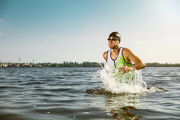 Image showing Professional triathlete swimming in river\'s open water