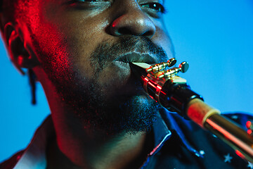 Image showing Young african-american jazz musician playing the saxophone