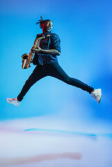 Image showing Young african-american jazz musician playing the saxophone