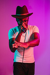 Image showing Young african-american jazz musician singing a song