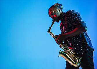 Image showing Young african-american jazz musician playing the saxophone