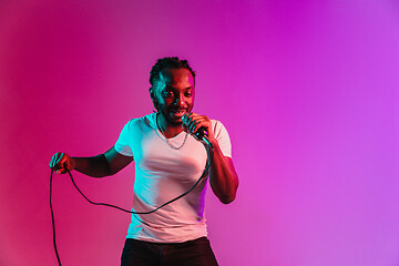 Image showing Young african-american jazz musician singing a song