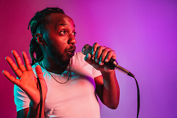 Image showing Young african-american jazz musician singing a song