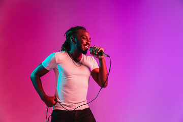 Image showing Young african-american jazz musician singing a song