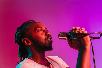 Image showing Young african-american jazz musician singing a song