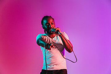 Image showing Young african-american jazz musician singing a song