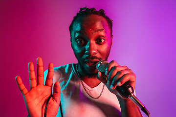 Image showing Young african-american jazz musician singing a song