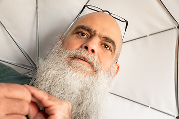 Image showing bearded man with glasses and umbrella