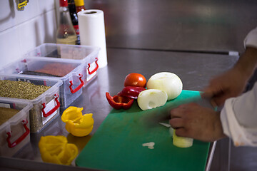 Image showing Chef hands cutting fresh and delicious vegetables