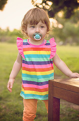 Image showing little girl spending time at backyard