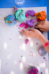 Image showing kid hands Playing with Colorful Clay