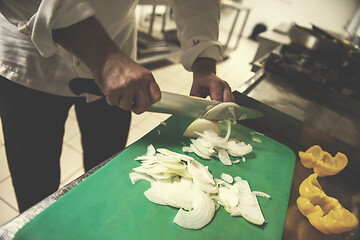 Image showing Chef hands cutting fresh and delicious vegetables