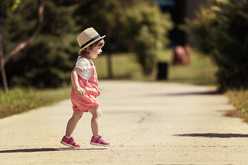 Image showing little girl runing in the summer Park