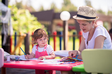 Image showing mom and little daughter drawing a colorful pictures