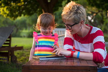 Image showing mom and her little daughter using tablet computer