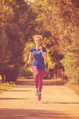 Image showing young female runner training for marathon