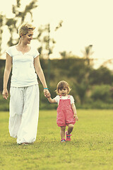 Image showing mother and little daughter playing at backyard