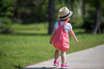 Image showing little girl runing in the summer Park