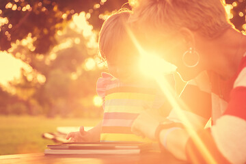 Image showing mom and her little daughter using tablet computer