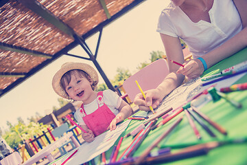 Image showing mom and little daughter drawing a colorful pictures