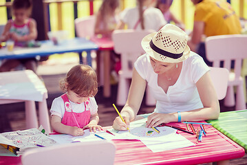 Image showing mom and little daughter drawing a colorful pictures