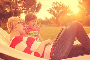 Image showing mom and a little daughter relaxing in a hammock