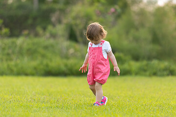 Image showing little girl spending time at backyard