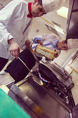 Image showing chef preparing food, frying in wok pan