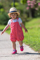 Image showing little girl runing in the summer Park