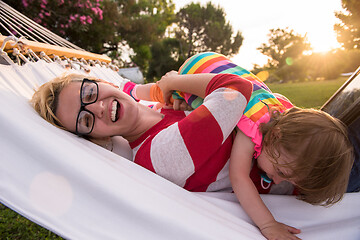 Image showing mom and a little daughter relaxing in a hammock