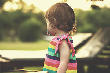 Image showing little girl spending time at backyard