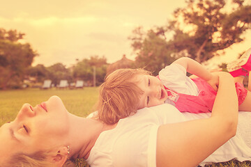 Image showing mother and little daughter playing at backyard