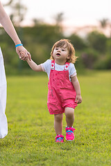 Image showing mother and little daughter playing at backyard