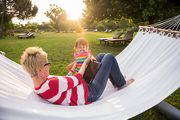 Image showing mom and a little daughter relaxing in a hammock