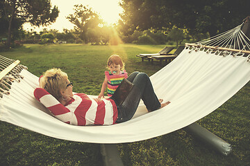 Image showing mom and a little daughter relaxing in a hammock