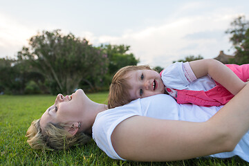 Image showing mother and little daughter playing at backyard