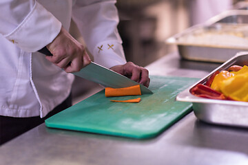 Image showing Chef hands cutting fresh and delicious vegetables