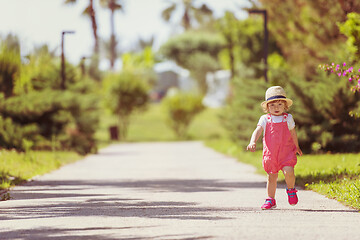 Image showing little girl runing in the summer Park