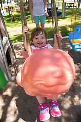 Image showing mother and daughter swinging in the park