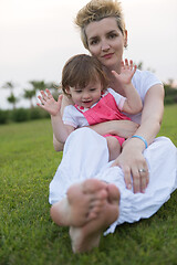 Image showing mother and little daughter playing at backyard