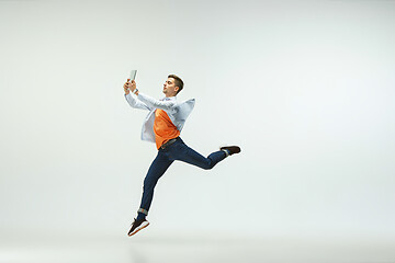 Image showing Man working at office and jumping isolated on studio background