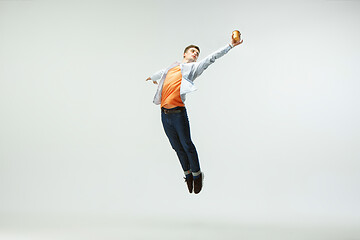 Image showing Man working at office and jumping isolated on studio background