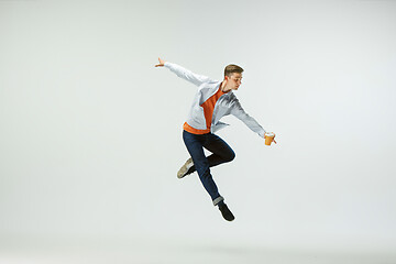 Image showing Man working at office and jumping isolated on studio background