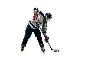 Image showing Young female hockey player with the stick isolated on white background