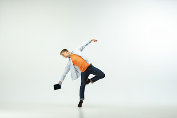 Image showing Man working at office and jumping isolated on studio background